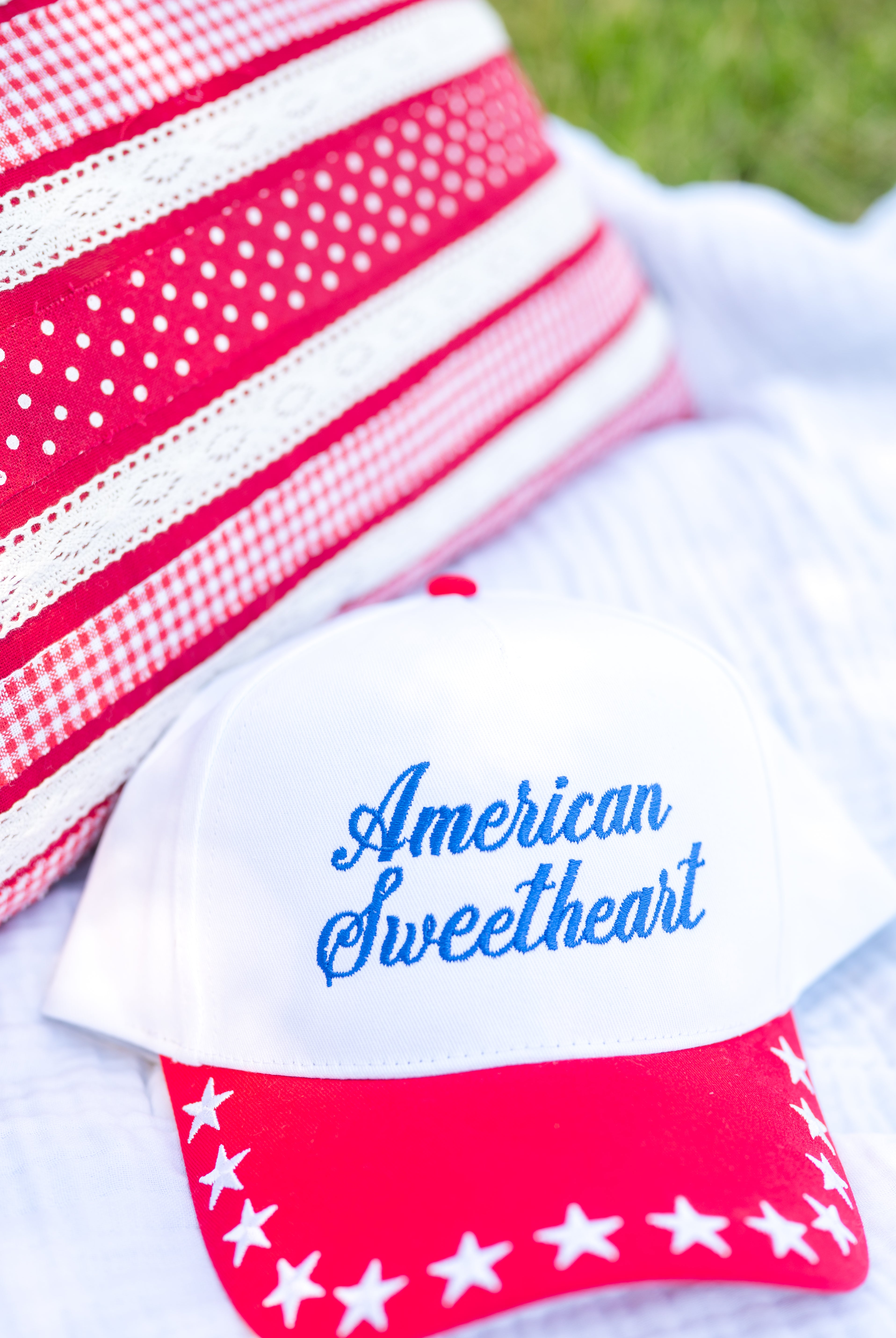Cap with 'American Sweetheart' text and red and white design on a white background, red white and blue, stars, snapback, summer hat, USA, Miss Americana hat