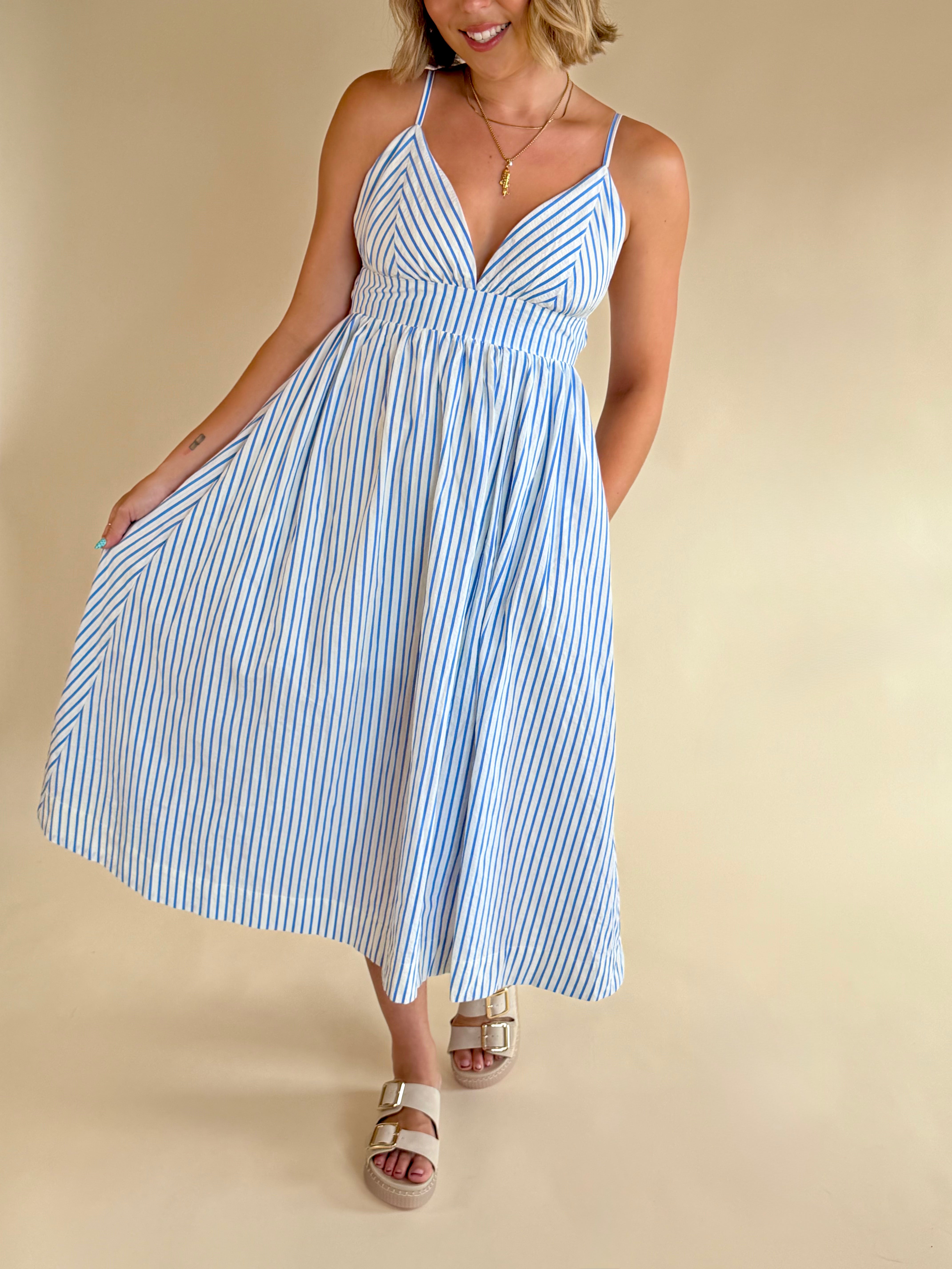 Woman wearing a blue and white striped dress on a beige background, blue and white stripe maxi, summer dress, elevated style, elegant dress, blue and white, pinstripe
