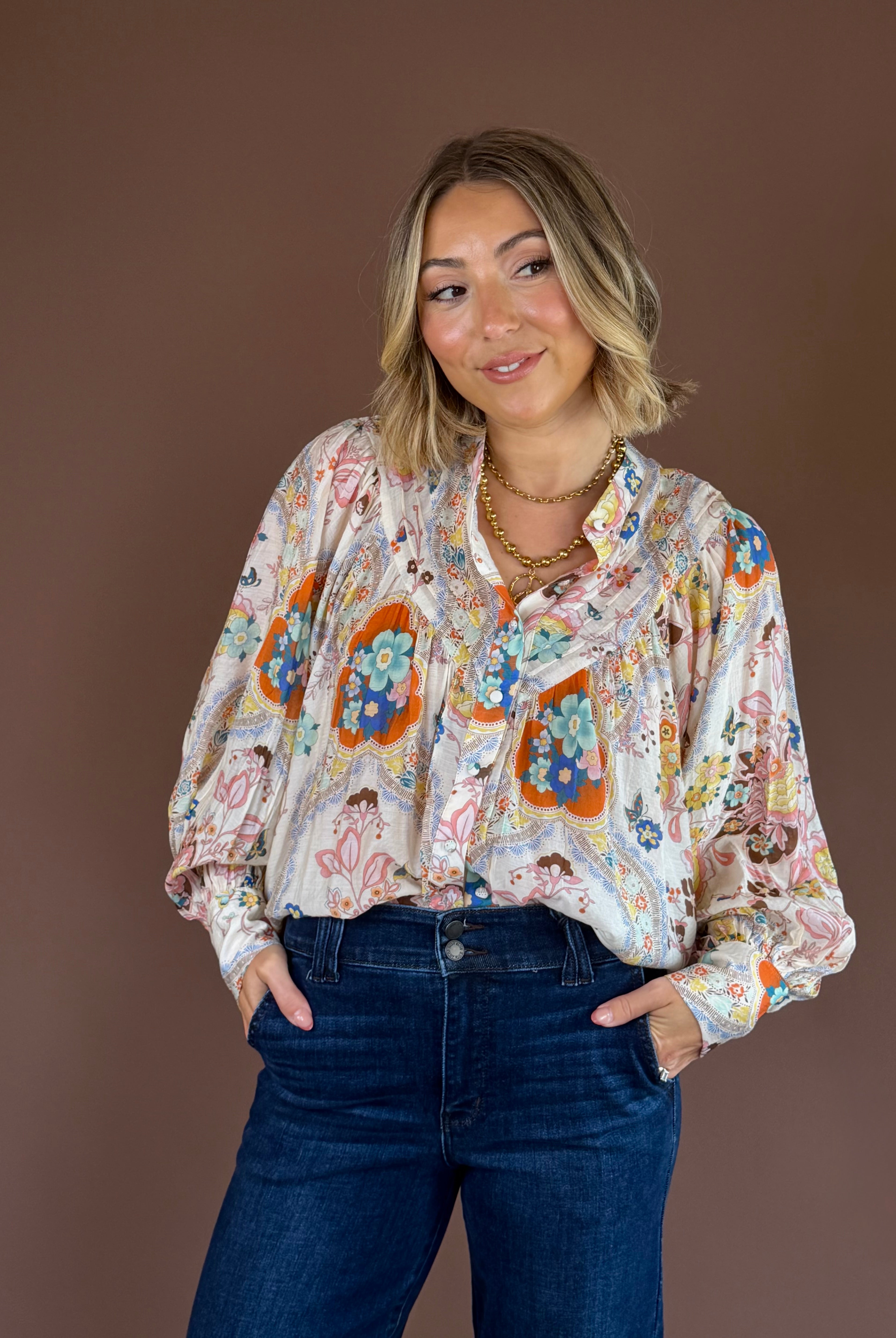Apricot paisley button-down blouse with a pleated high neckline, long sleeves, and a relaxed fit.