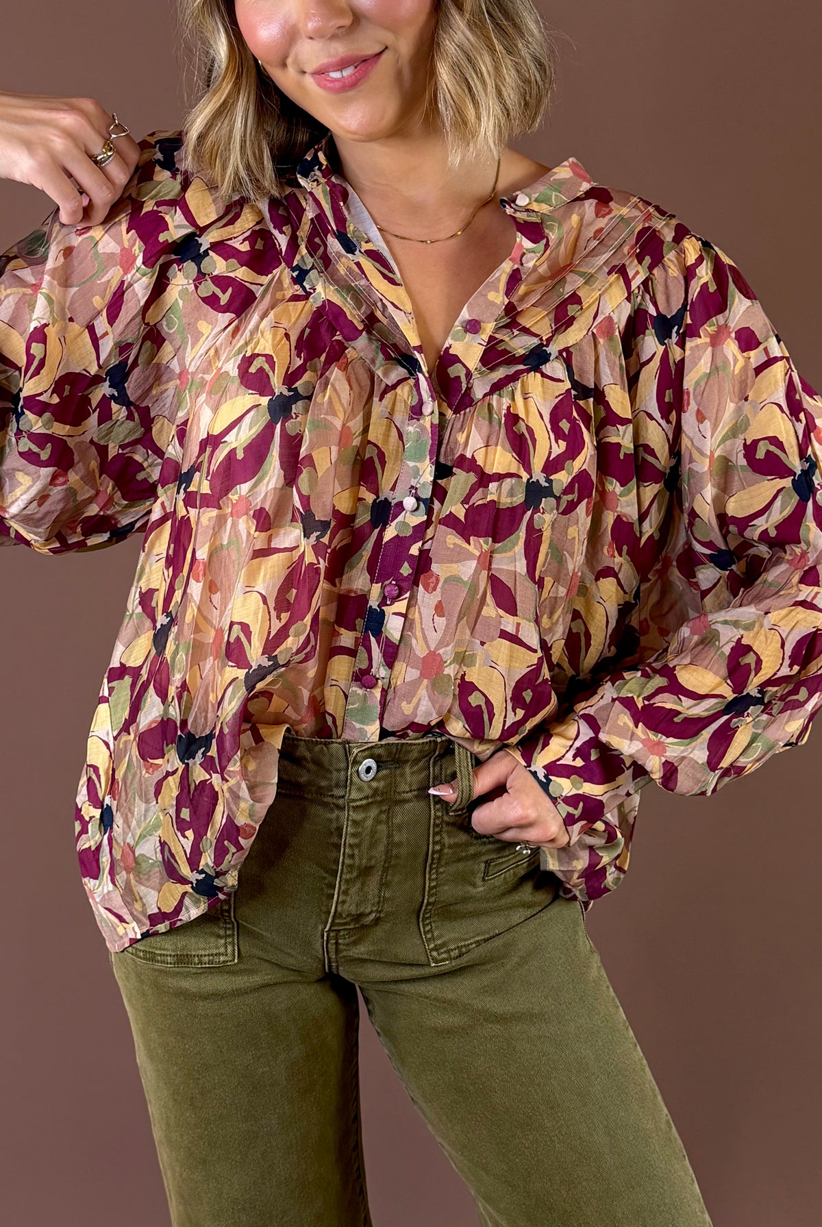 Burgundy Blooms Blouse featuring wine floral print button up blouse with pleated details and long sleeves