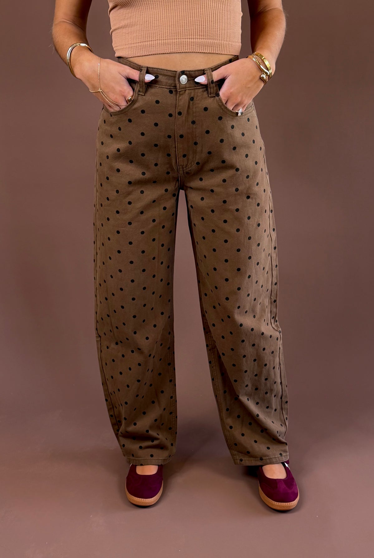 Cocoa Dot women’s brown mineral-wash jeans with an allover polka-dot print, curved barrel-leg silhouette, and button-and-zip closure
