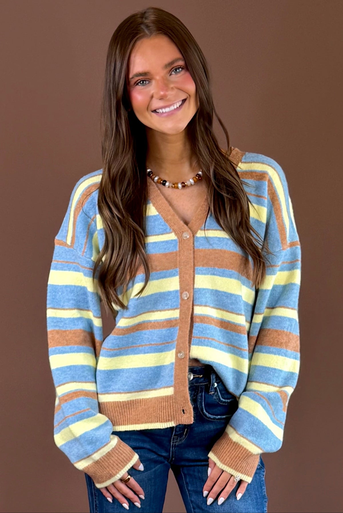 Color Me Cozy women’s multicolor striped knit cardigan with a V-neckline, long sleeves, button front, and retro-inspired color palette