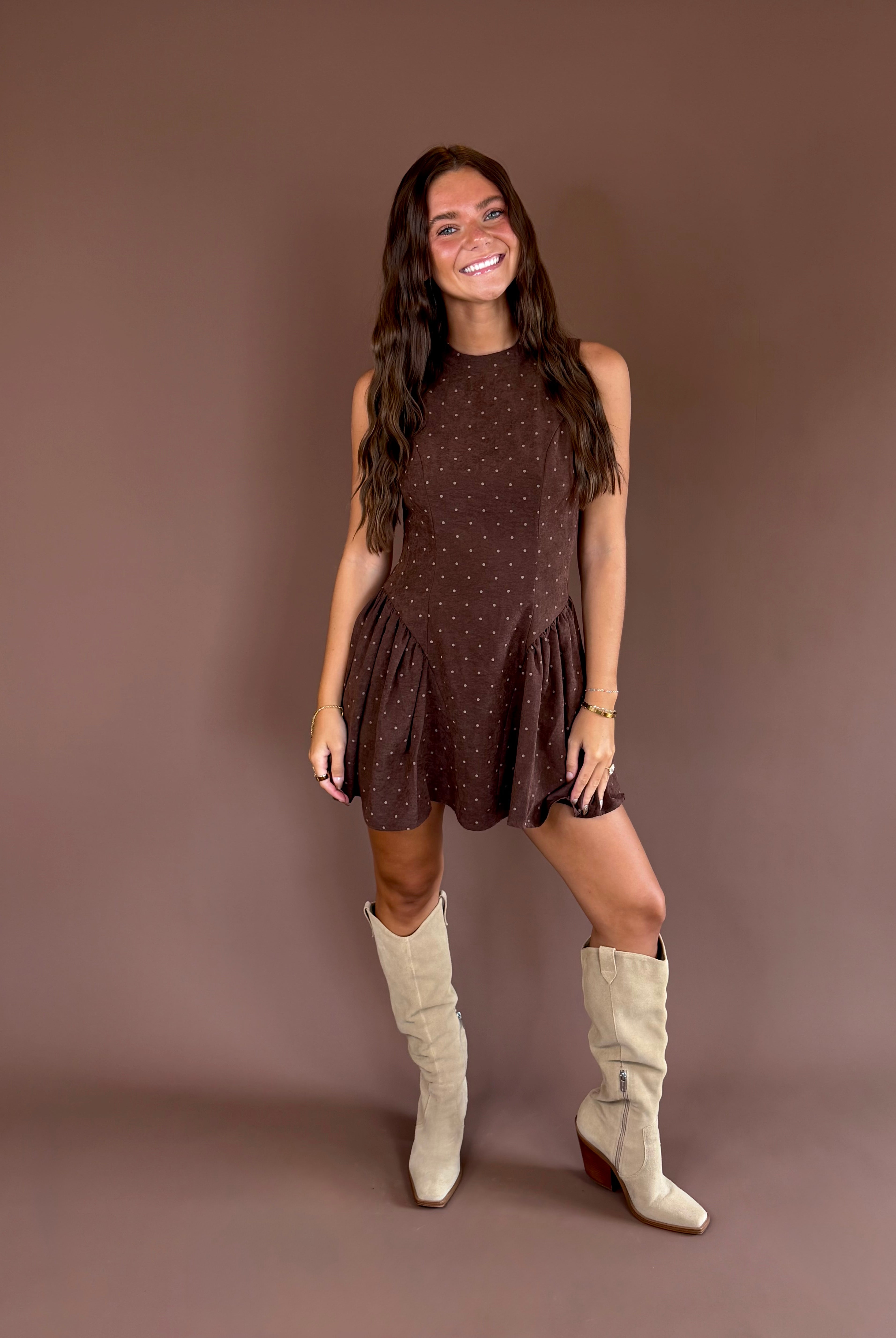 Hazelnut Honey women’s dark brown polka-dot mini dress with brushed satin fabric, a high neckline, and pleated basque waist.