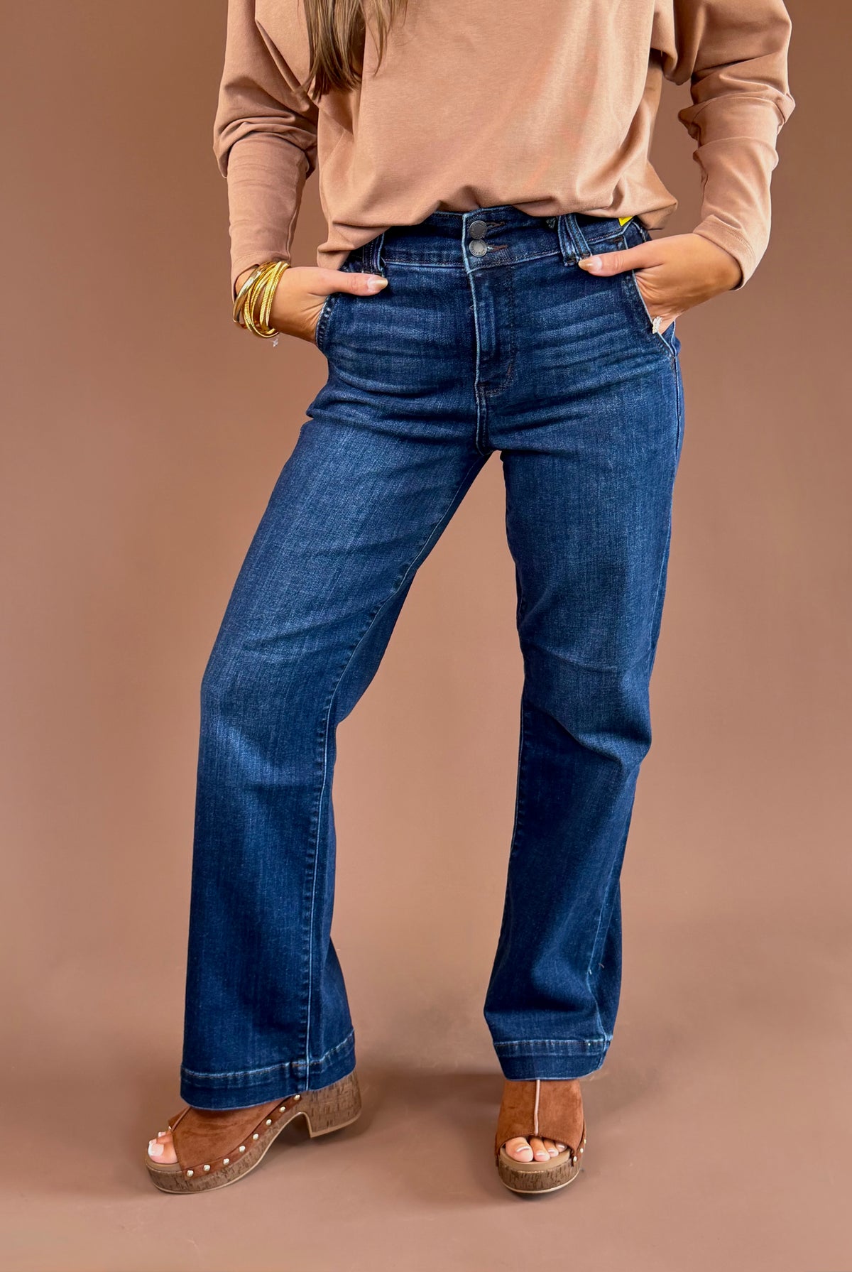 Dark-wash Judy Blue stretch jeans with a high rise, wide trouser leg, finished hem, and 31-inch inseam.