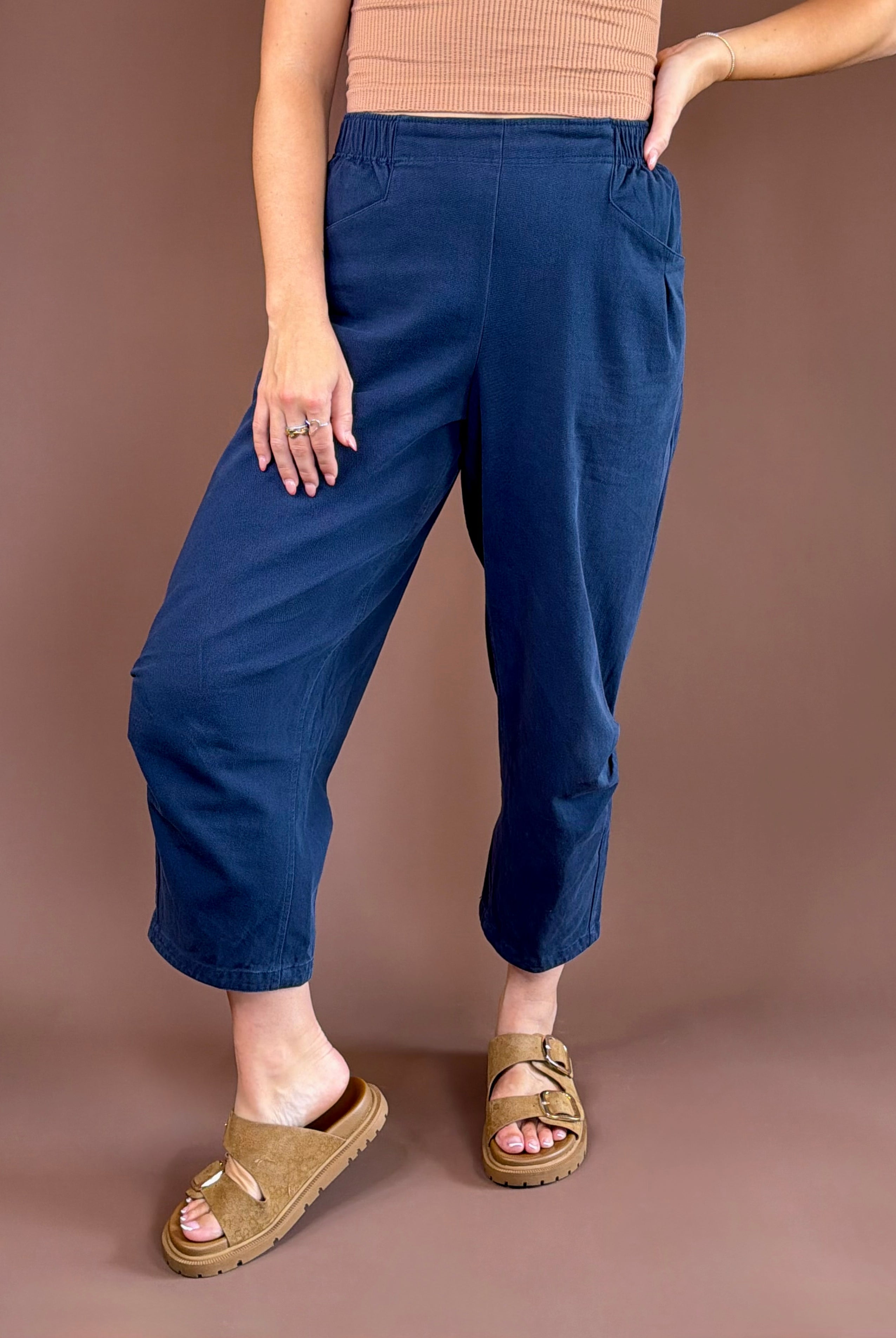 Midnight blue mineral-wash cotton pants with a high rise, pleated wide leg, elastic waist, and pockets.