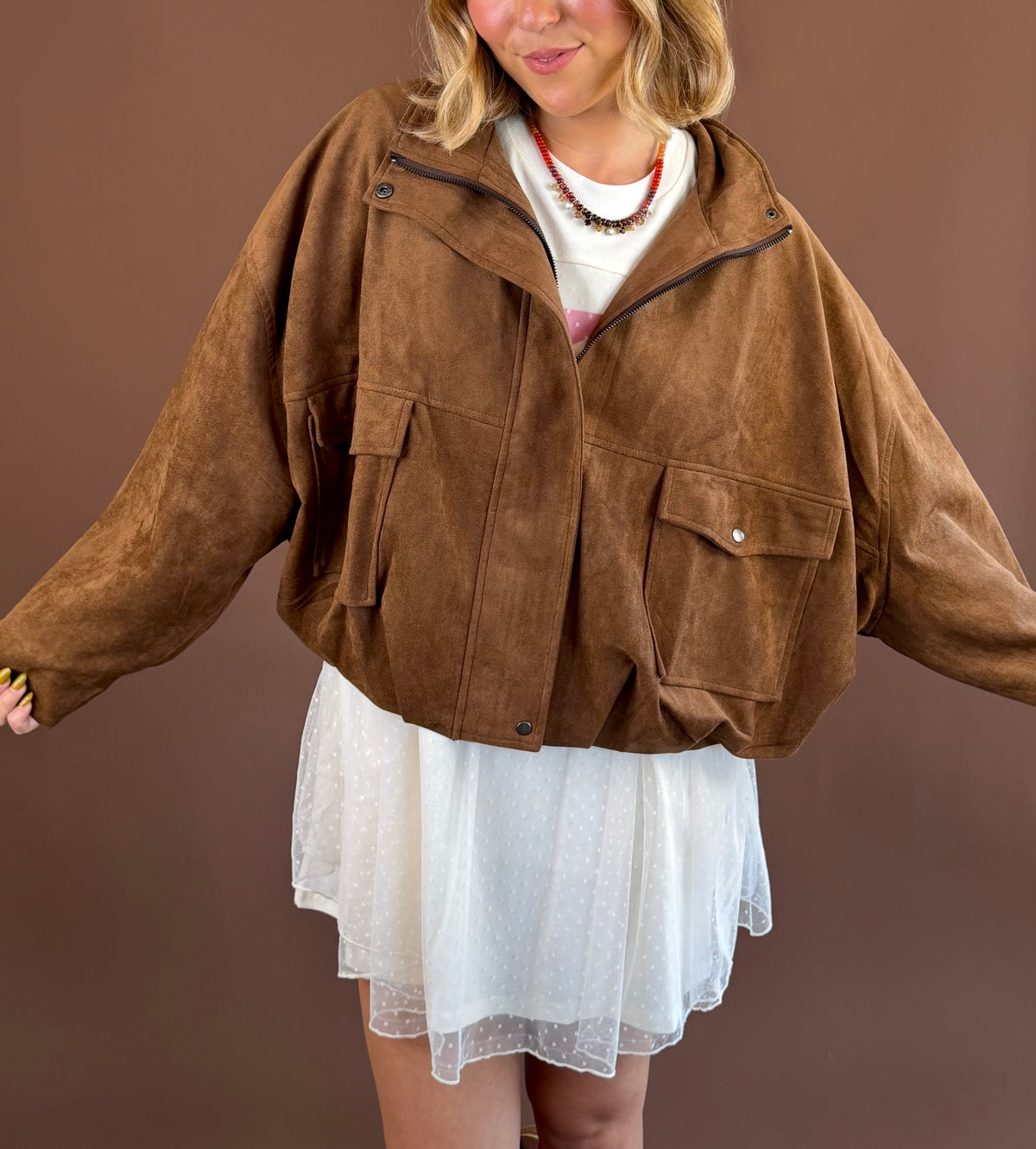 Mocha Mood women's mocha-brown suede jacket with a funnel neckline, zip-front closure, long sleeves, and front pockets.