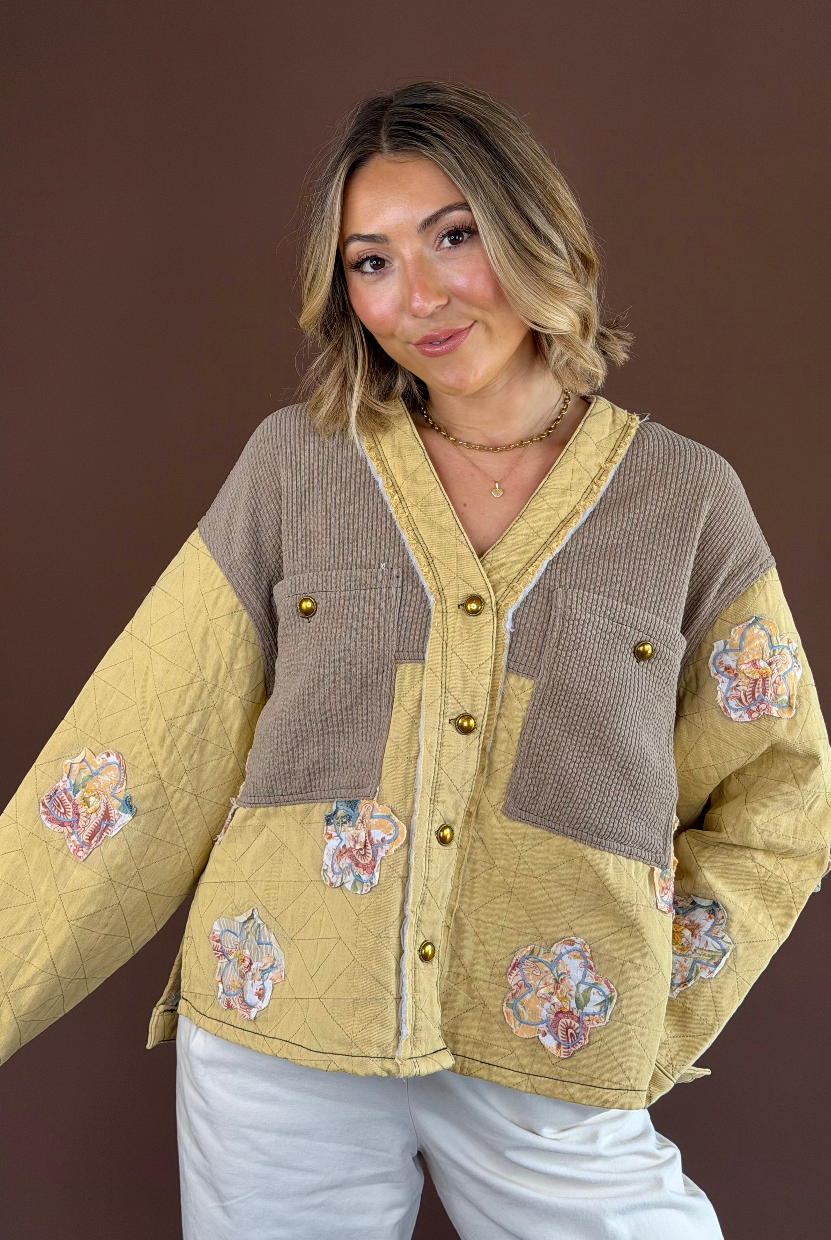 Warm golden-yellow quilted jacket with a button-front closure, long sleeves, and relaxed boho silhouette.