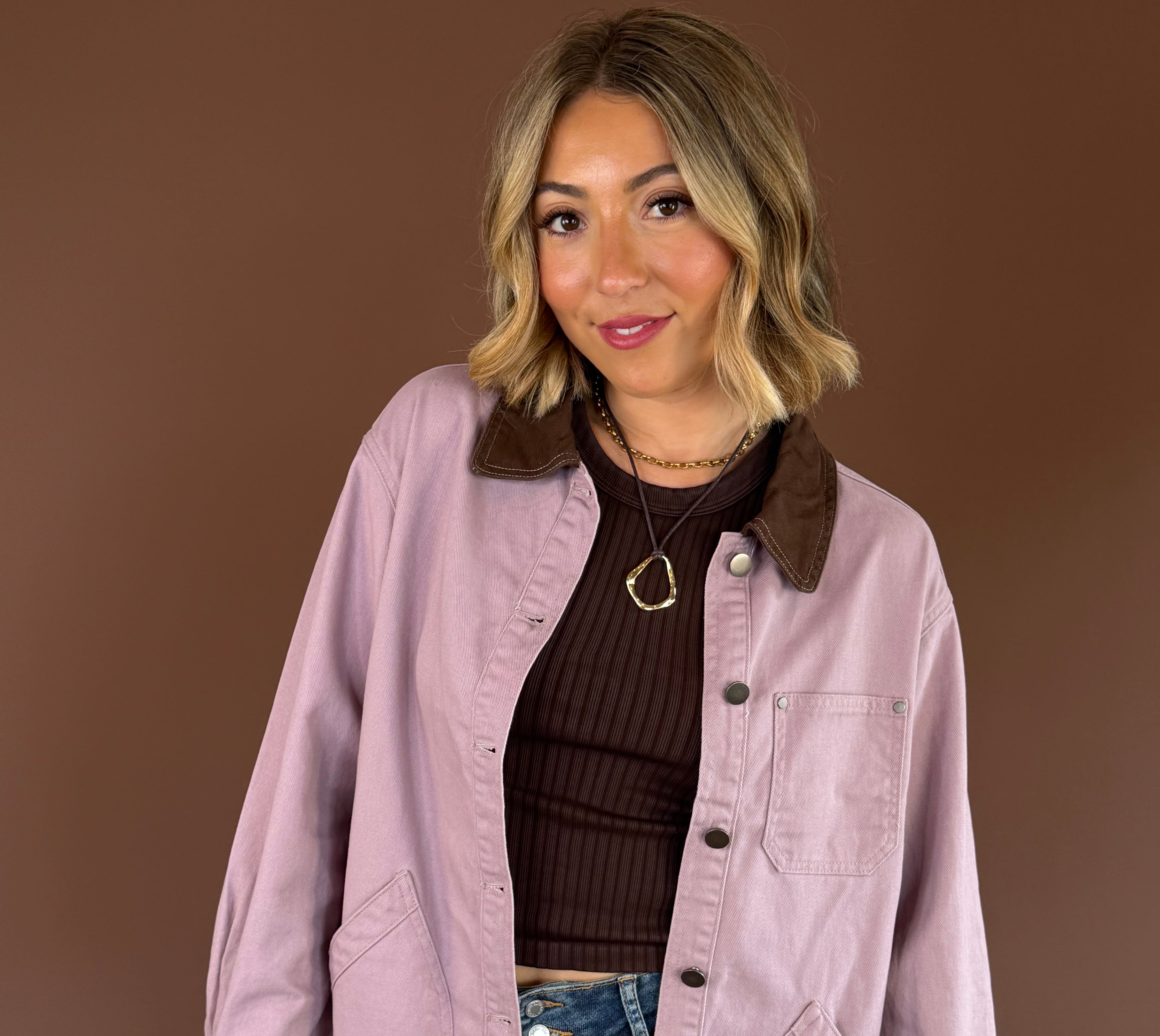 Raspberry Mocha women’s mauve denim barn coat with contrasting mocha brown trim, long sleeves, and roomy front pockets.