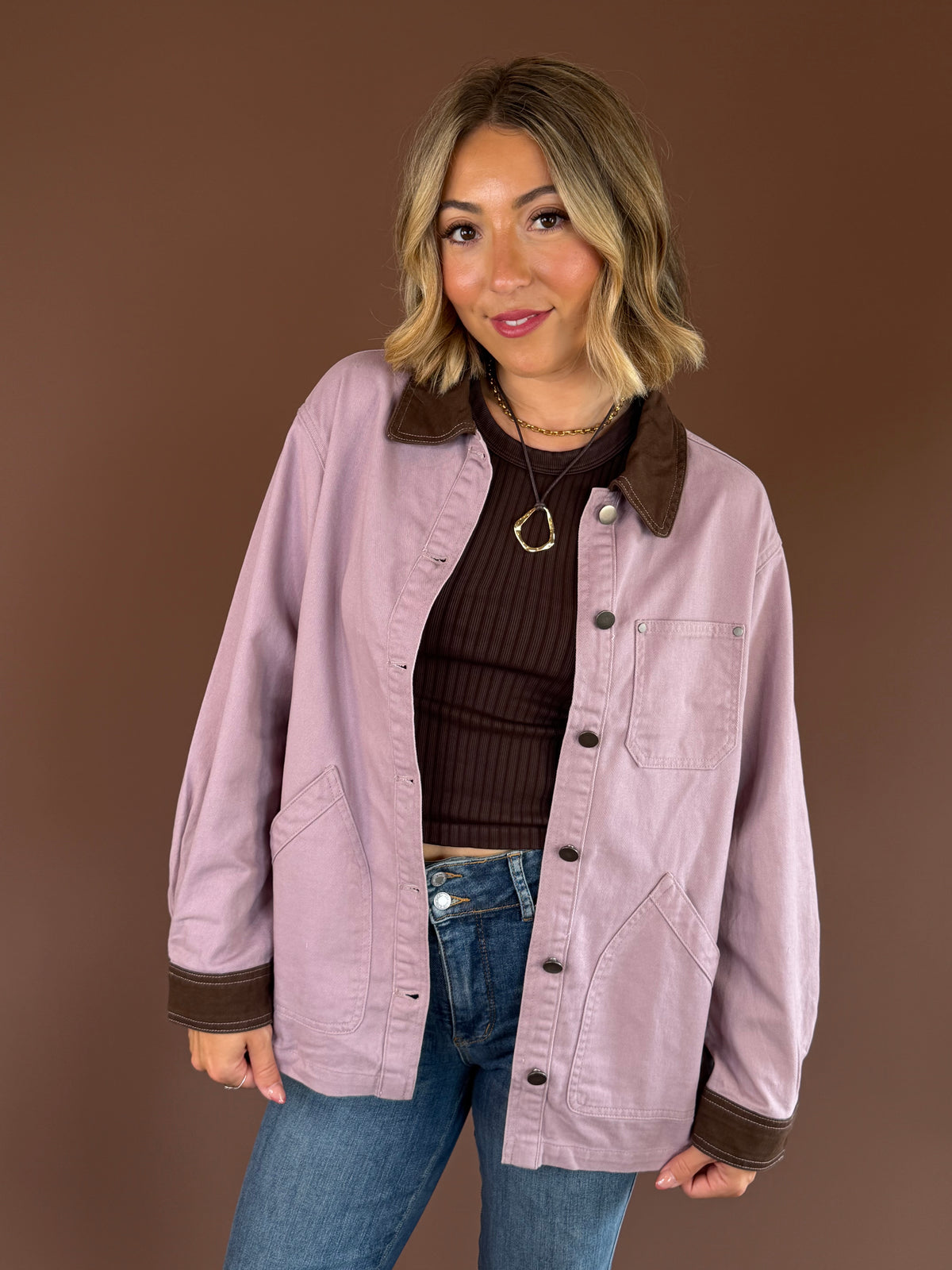 Raspberry Mocha women’s mauve denim barn coat with contrasting mocha brown trim, long sleeves, and roomy front pockets.