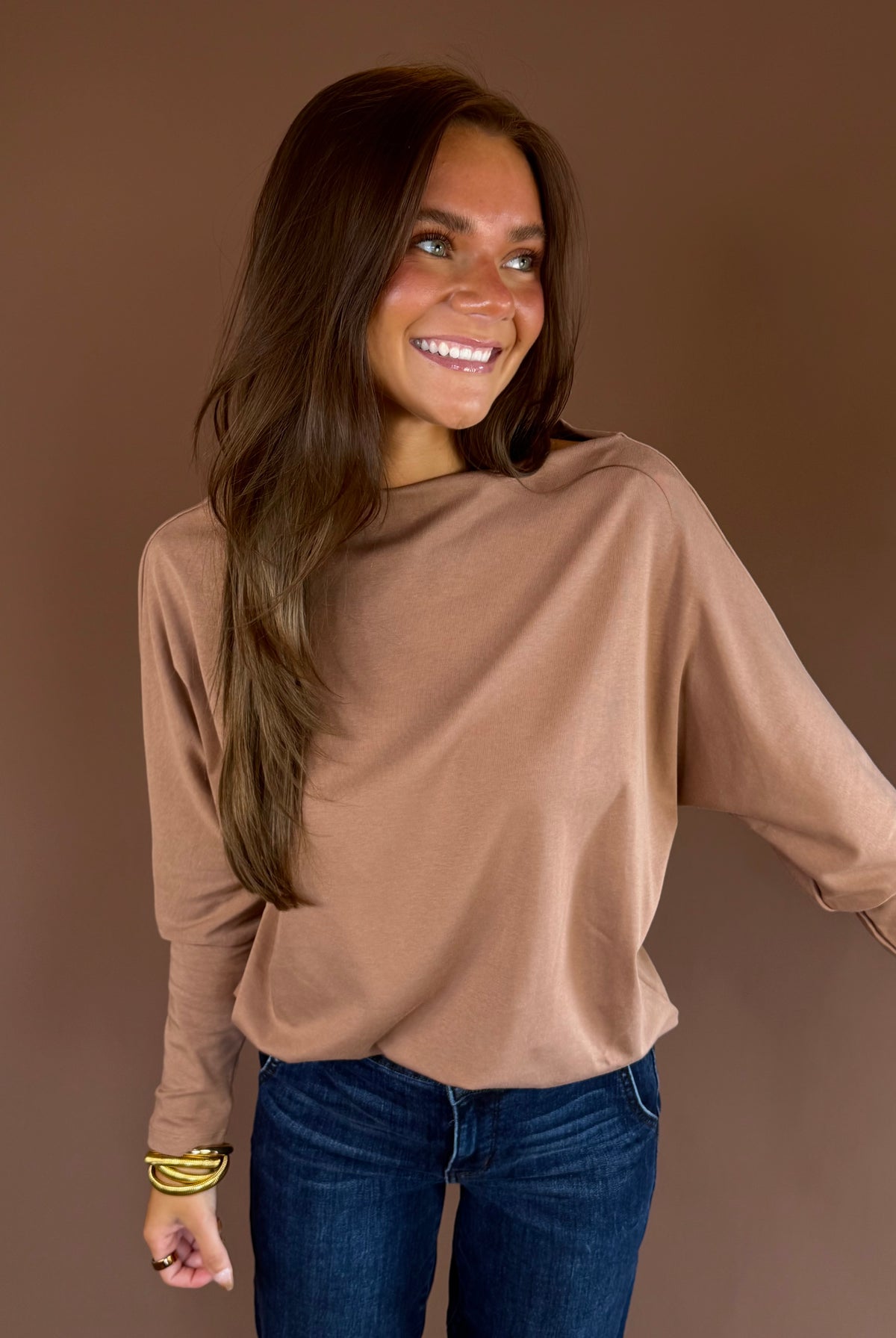 Almond brown knit sweater with a wide boat neckline, long dolman sleeves, and relaxed silhouette.
