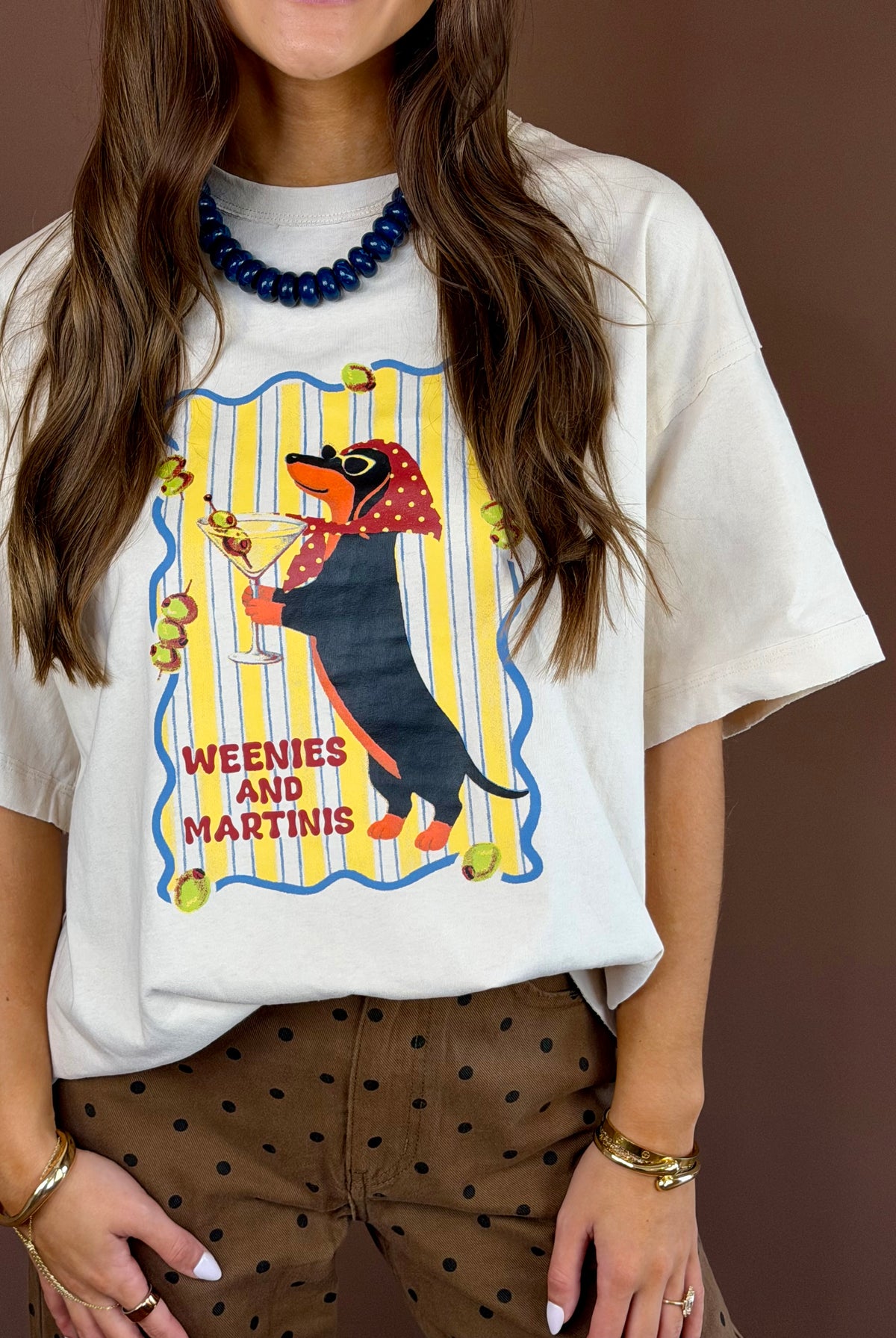 Weenies and Martinis women’s bone-white washed graphic T-shirt with a round neckline, short sleeves, and relaxed oversized fit