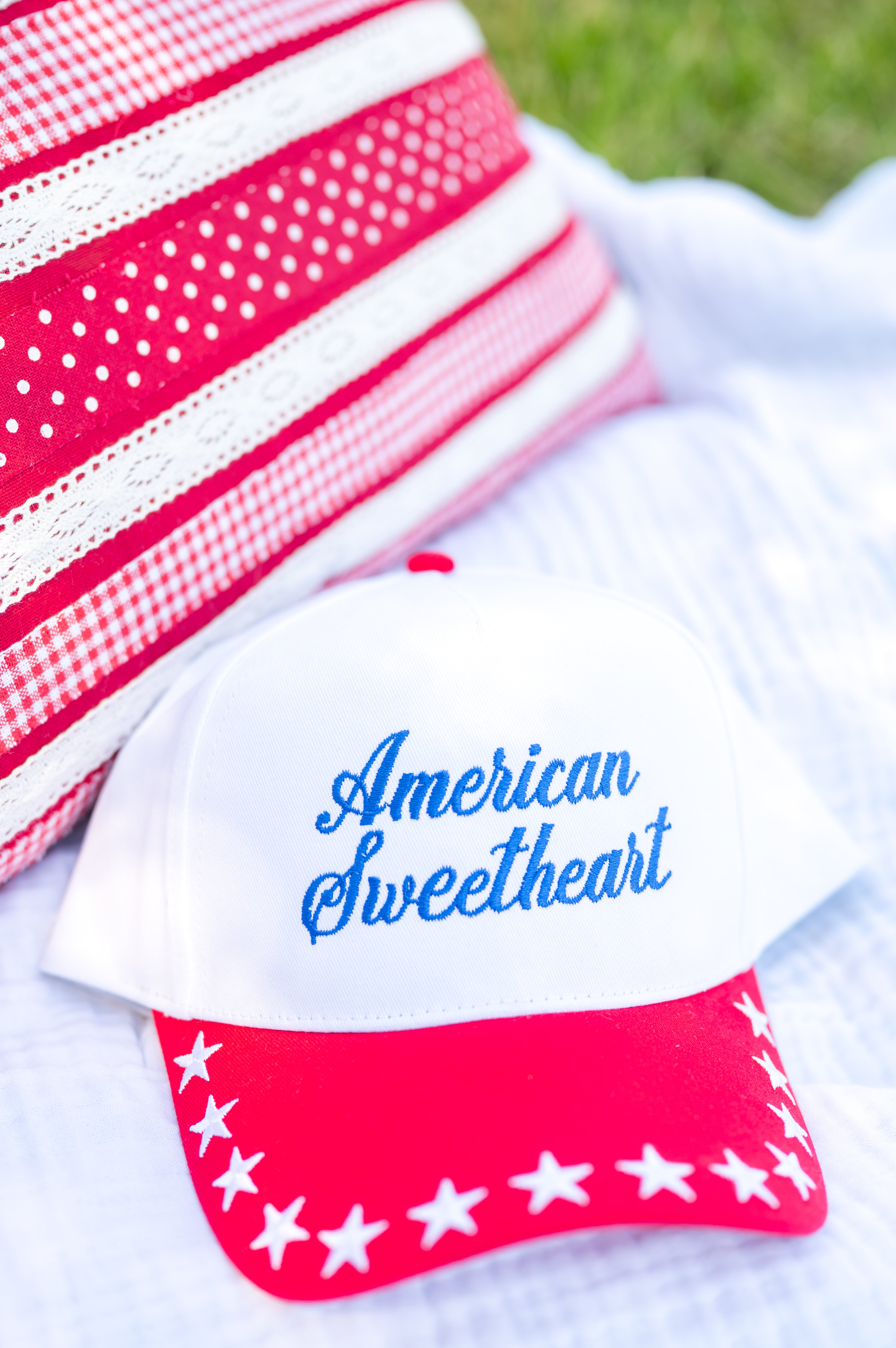Cap with 'American Sweetheart' text and red and white design on a white background, red white and blue, stars, snapback, summer hat, USA, Miss Americana hat
