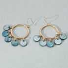 Gold hoop earrings with blue disc charms on a light gray background, shell pattern, gold earring, deep blue detail, dangle and hoop, gift, accessory 