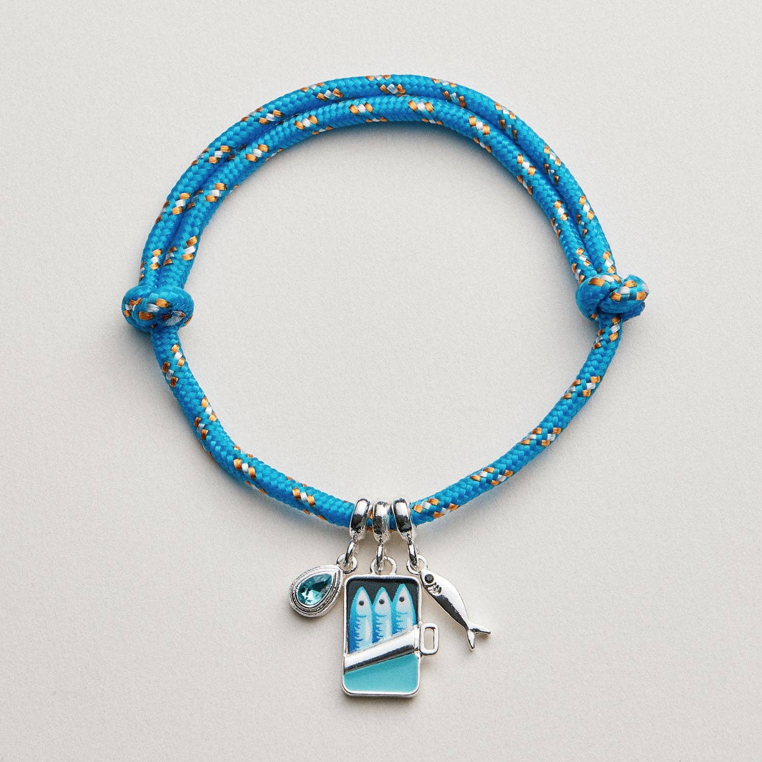 Blue braided bracelet with charms on a light gray background, bracelet, accessories, gifts, rope bracelet, sardine charm 