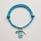 Blue braided bracelet with charms on a light gray background, bracelet, accessories, gifts, rope bracelet, sardine charm 
