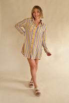 Woman wearing a yellow and blue striped shirt dress on a beige background, summer style, blue and yellow stripe, gauze dress, long sleeve dress, summer style, stripe print dress 