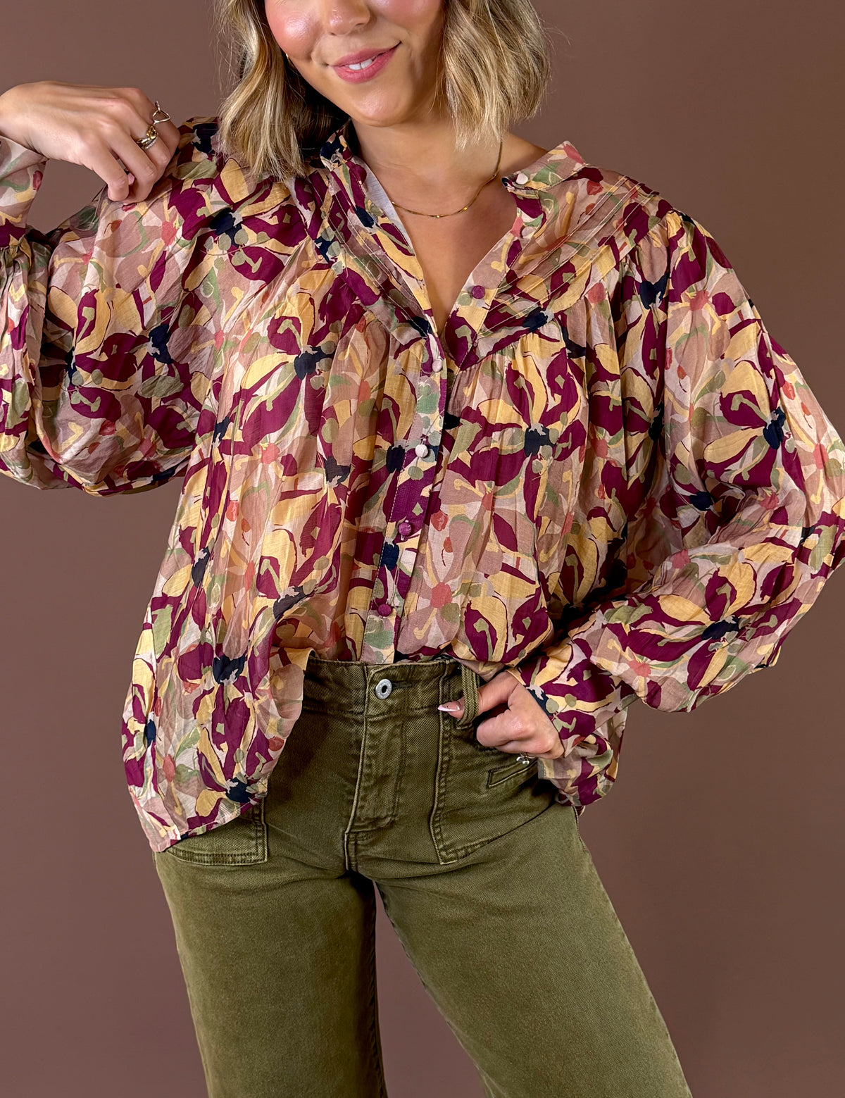 Burgundy Blooms Blouse featuring wine floral print button up blouse with pleated details and long sleeves