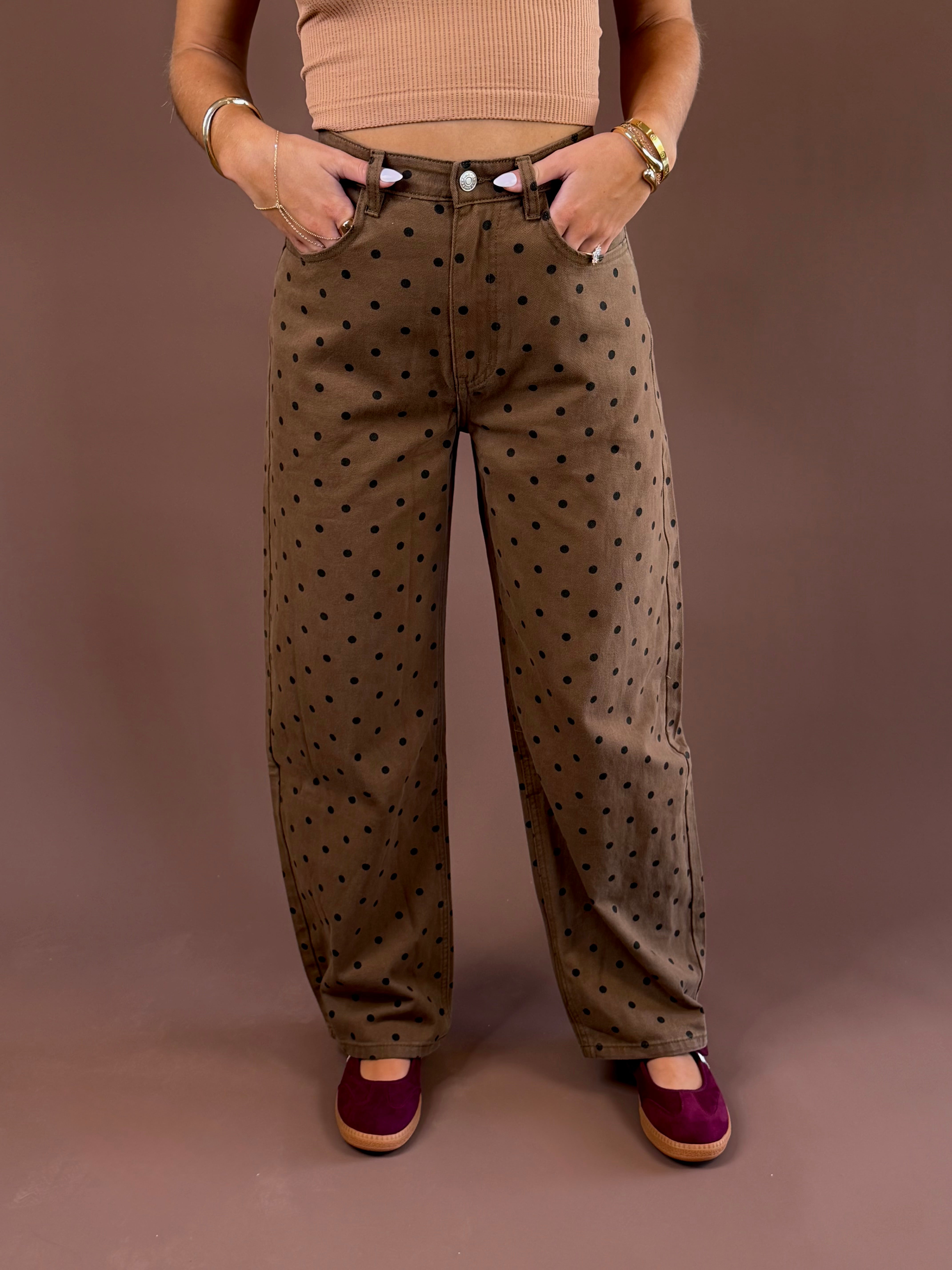 Cocoa Dot women’s brown mineral-wash jeans with an allover polka-dot print, curved barrel-leg silhouette, and button-and-zip closure