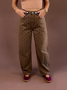 Cocoa Dot women’s brown mineral-wash jeans with an allover polka-dot print, curved barrel-leg silhouette, and button-and-zip closure