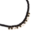 Erimish Kennedy beaded necklace with glossy beads and delicate gold-set crystal charms, combining dark and luminous stones.