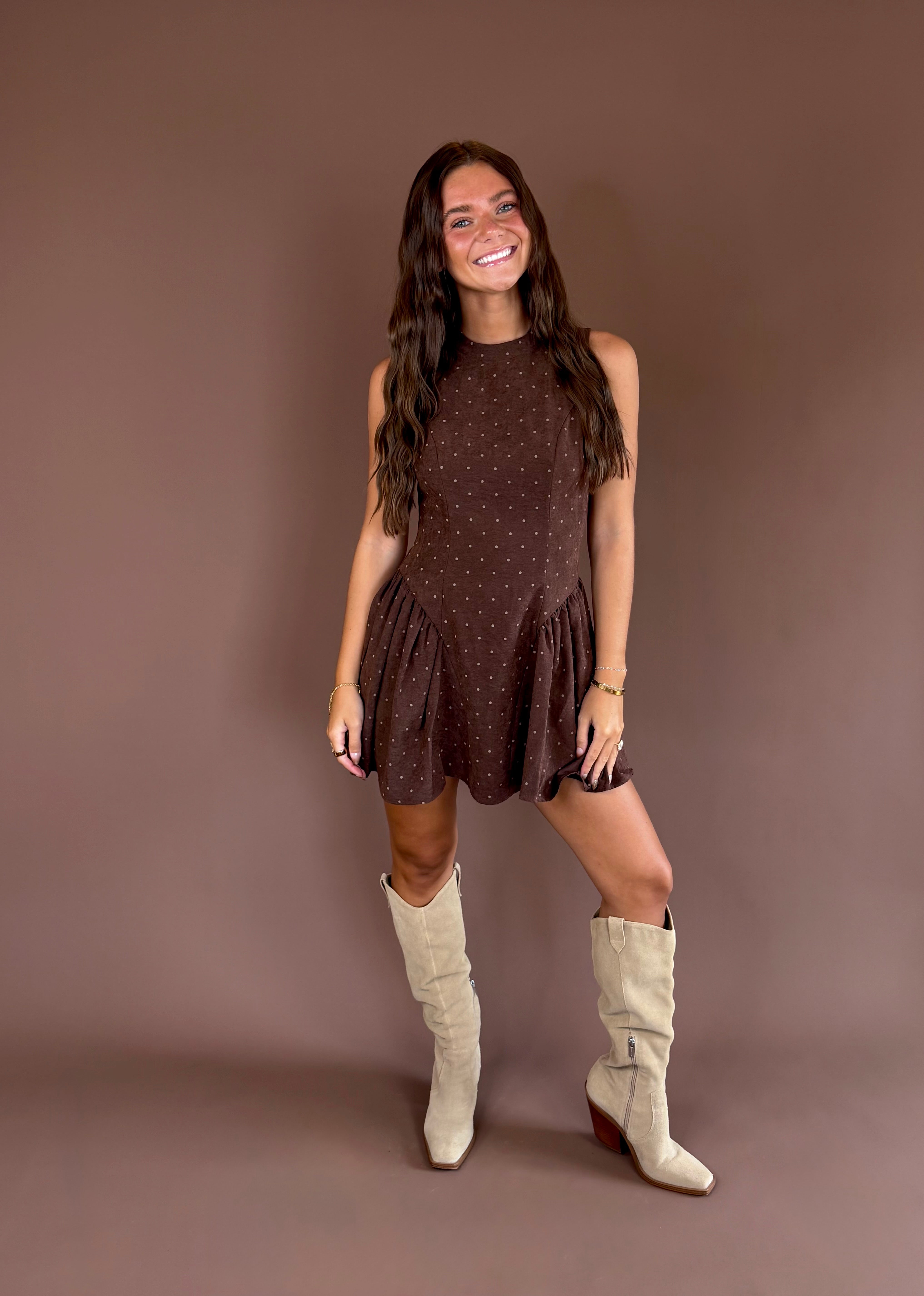 Hazelnut Honey women’s dark brown polka-dot mini dress with brushed satin fabric, a high neckline, and pleated basque waist.