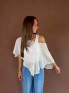 Cream ivory sheer poncho top with a cropped flowy silhouette and adjustable slouch neckline.