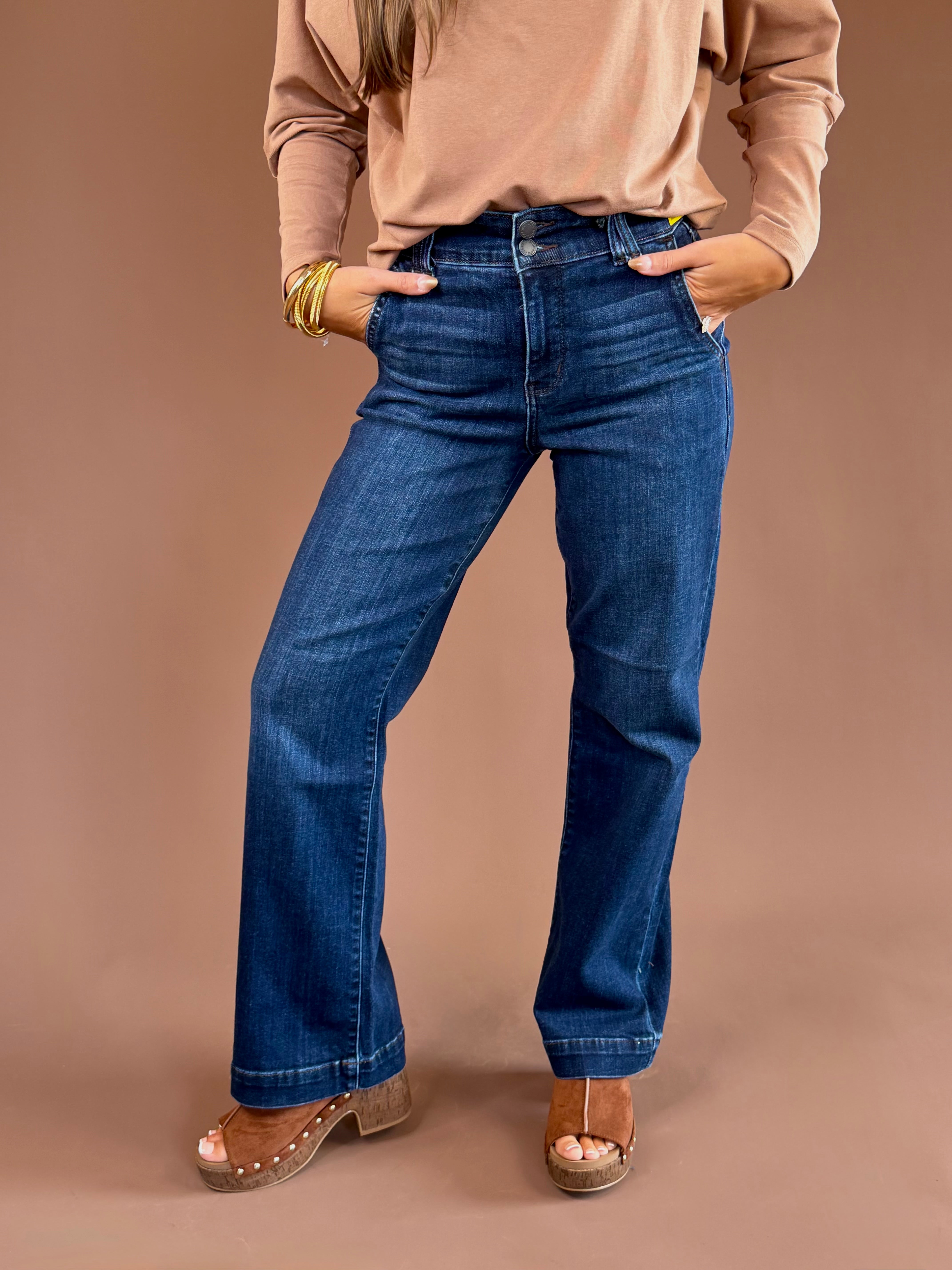 Dark-wash Judy Blue stretch jeans with a high rise, wide trouser leg, finished hem, and 31-inch inseam.