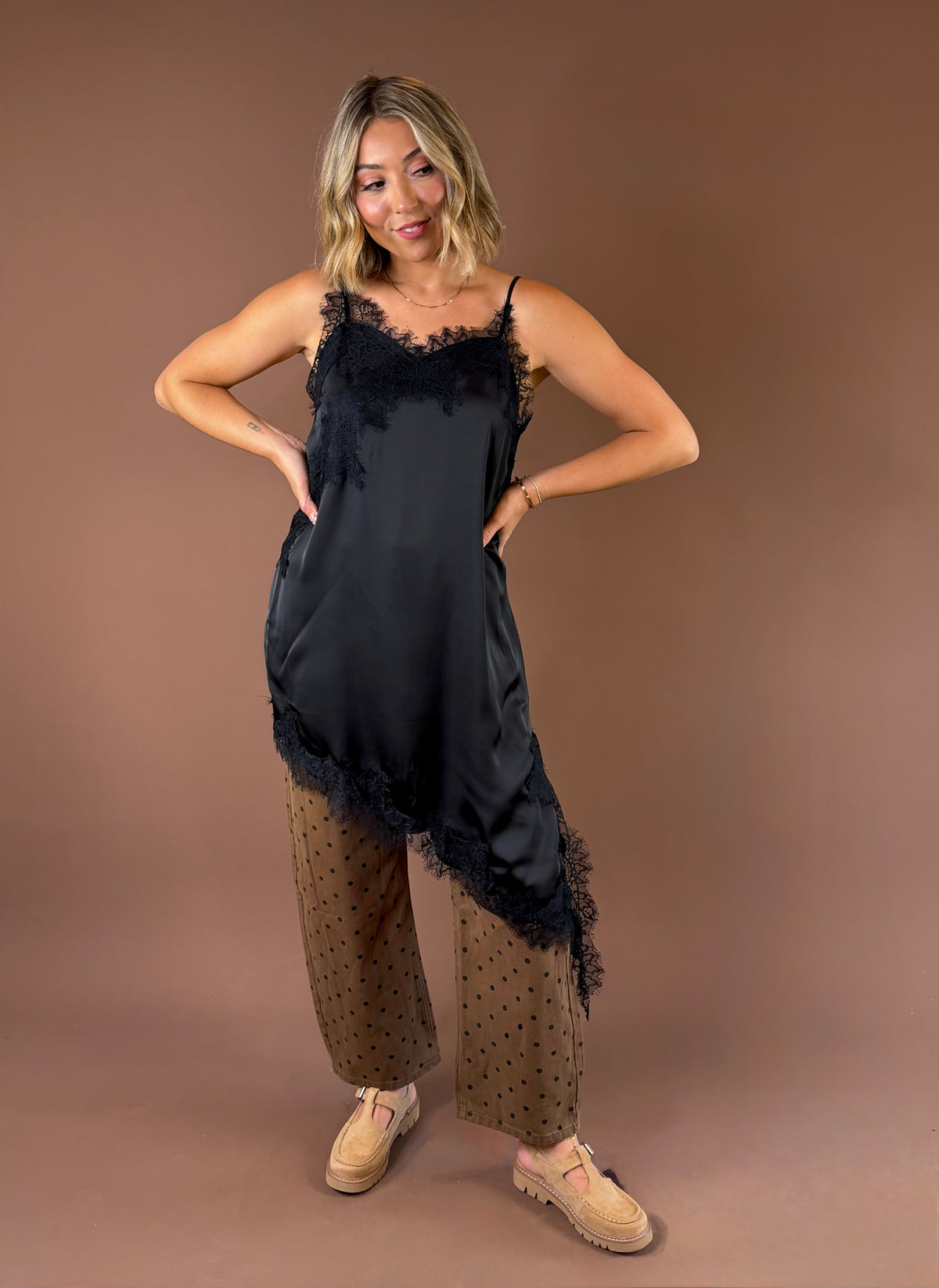 Love Story women’s black satin slip mini tunic dress with delicate lace detailing, adjustable spaghetti straps, and an asymmetrical hem