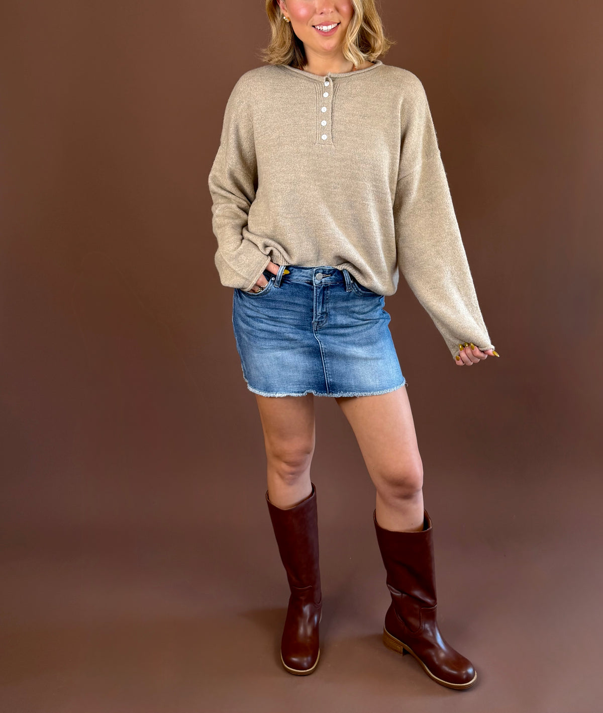 MICA women's medium-wash denim mini skirt with a mid-rise waist and unfinished raw-edge hem.