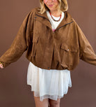 Mocha Mood women's mocha-brown suede jacket with a funnel neckline, zip-front closure, long sleeves, and front pockets.
