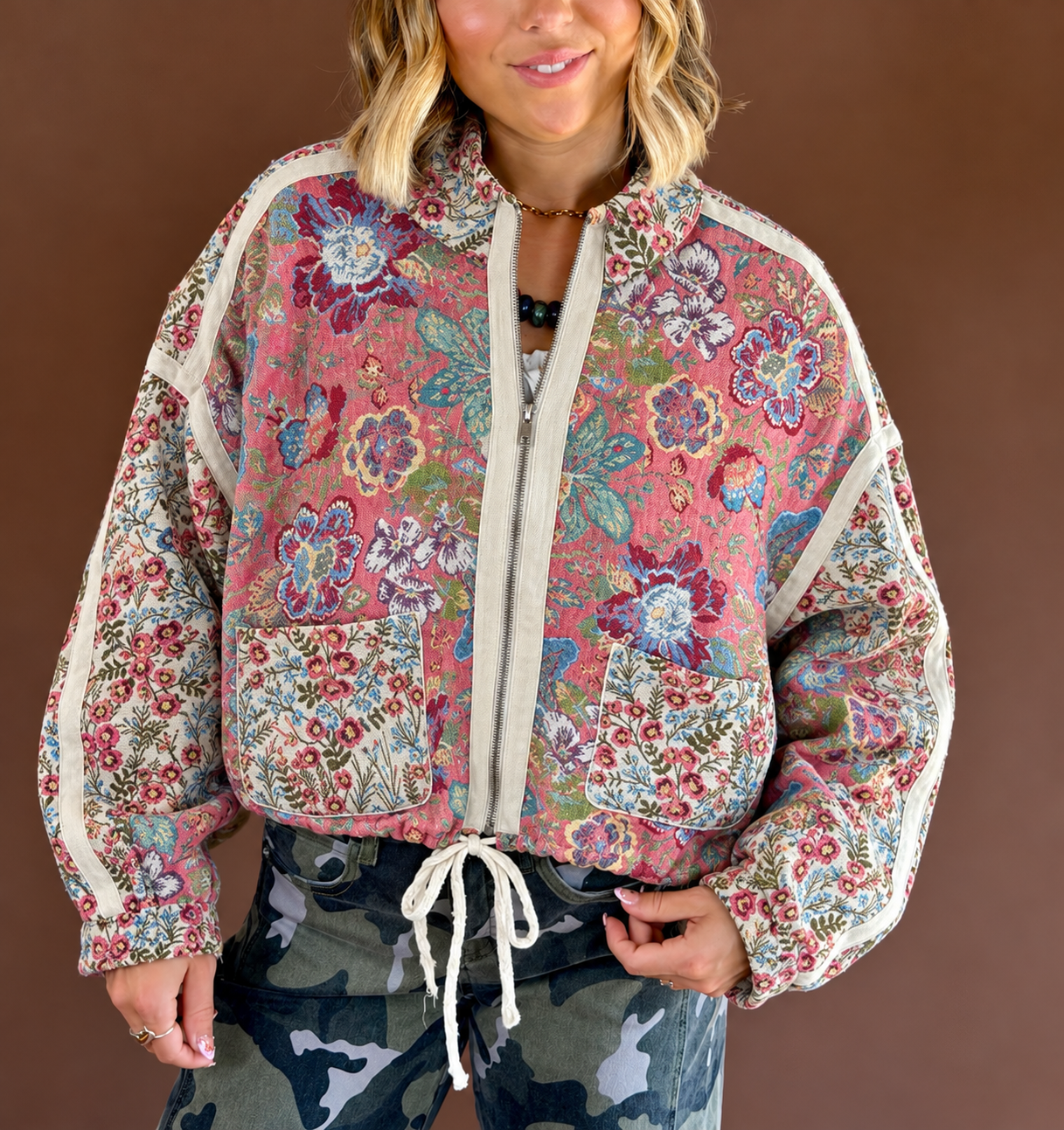 Petal Poetry women's rose-pink floral jacquard jacket with a high neckline, zip-front closure, front pockets, and adjustable cinch detailing.