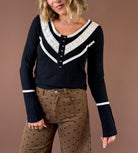POL After Midnight women’s black V-neck blouse with contrasting cream lace accents, decorative buttons, mixed textures, and flared long sleeves
