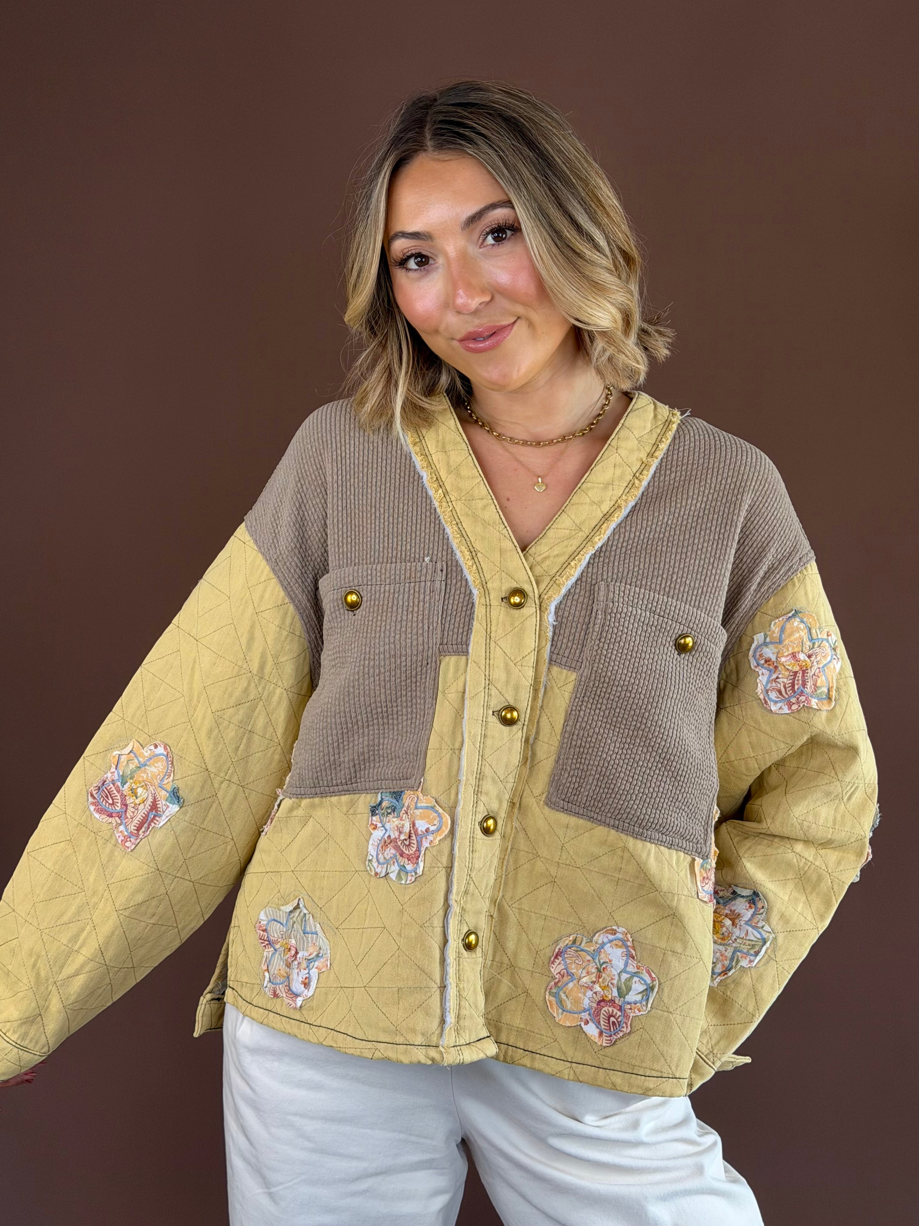 Warm golden-yellow quilted jacket with a button-front closure, long sleeves, and relaxed boho silhouette.