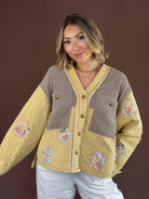 Warm golden-yellow quilted jacket with a button-front closure, long sleeves, and relaxed boho silhouette.