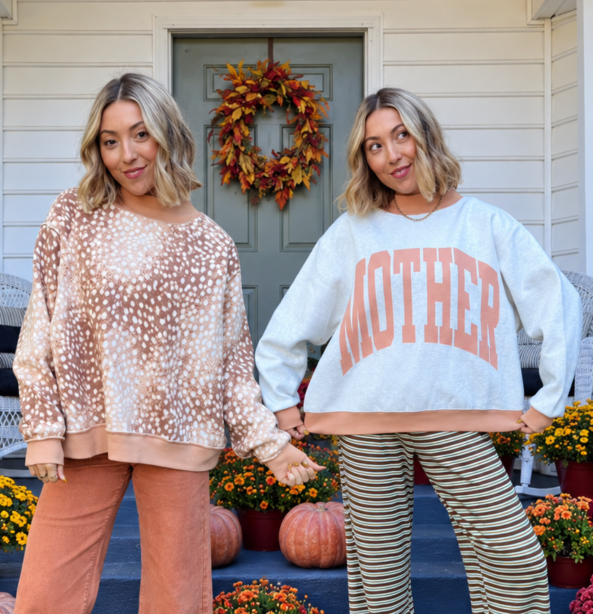 Two views of a reversible mockneck sweatshirt: one side in a tan and cream fawn spotted print and the other in light blue with coral MOTHER varsity lettering.