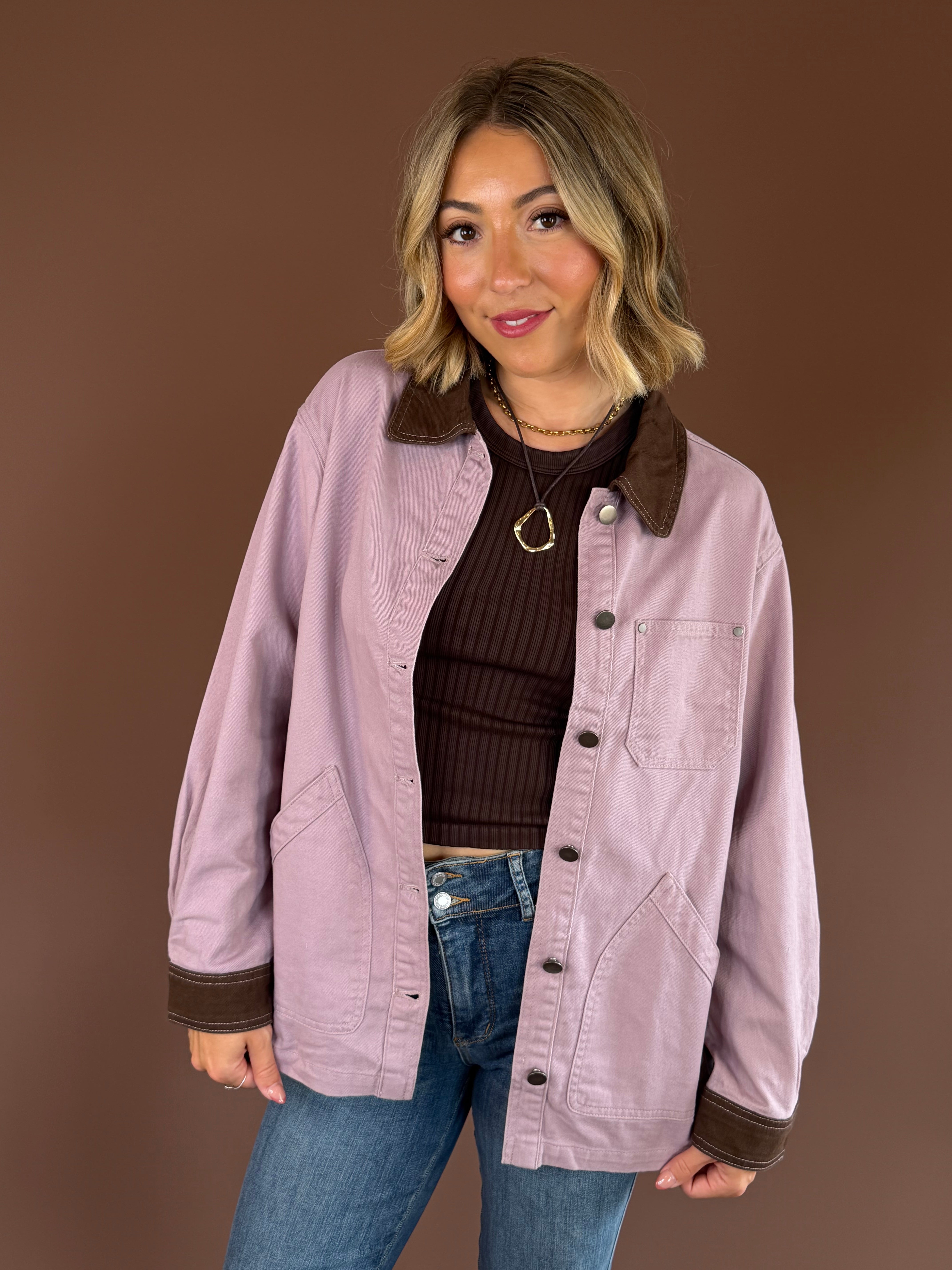 Raspberry Mocha women’s mauve denim barn coat with contrasting mocha brown trim, long sleeves, and roomy front pockets.
