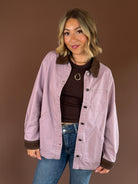 Raspberry Mocha women’s mauve denim barn coat with contrasting mocha brown trim, long sleeves, and roomy front pockets.