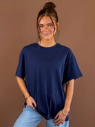 Model wearing a true navy relaxed boyfriend T-shirt with a round neckline and short sleeves, styled with blue jeans.