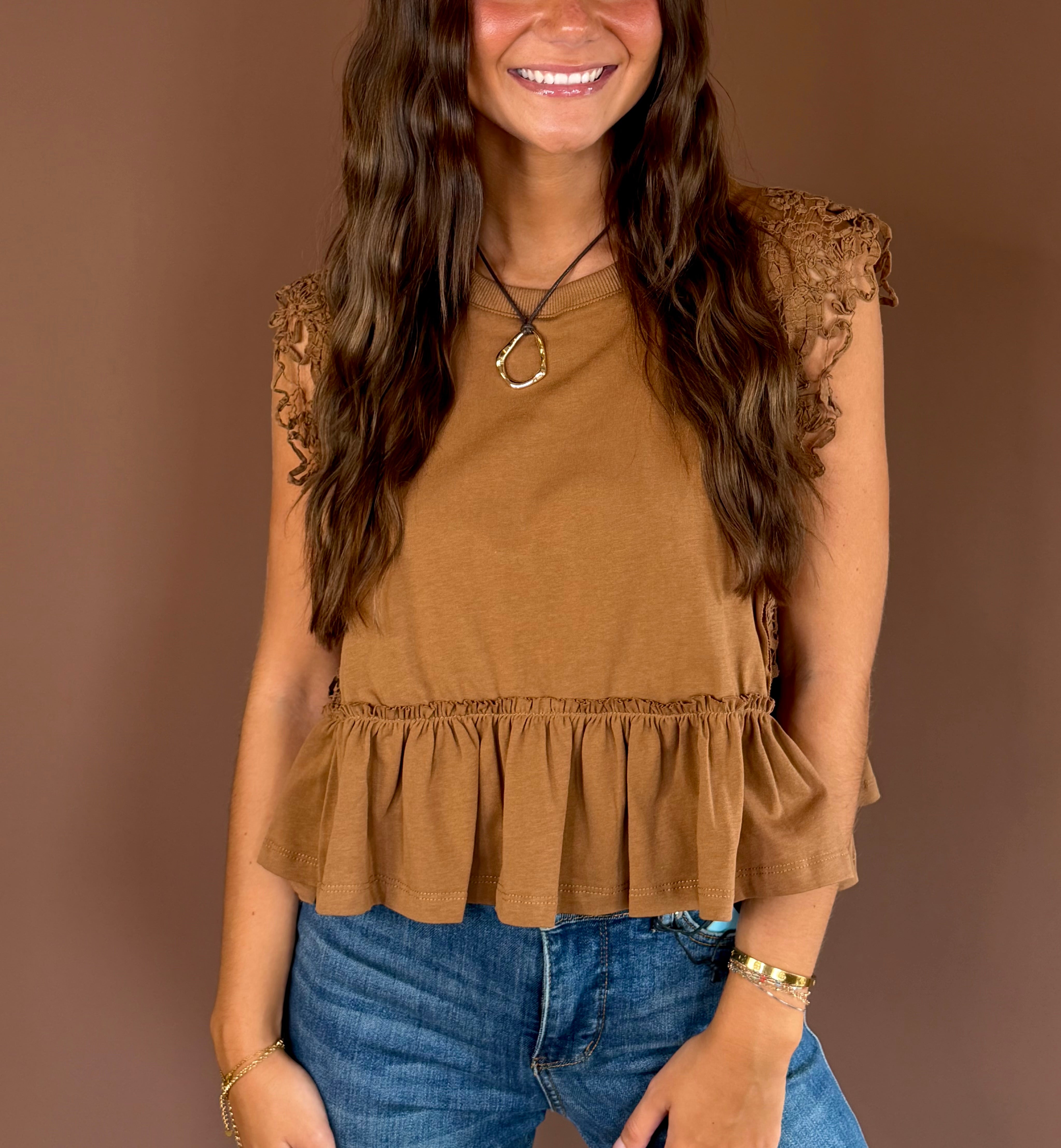 Simply Lovely women’s cinnamon cotton top with cap sleeves, a round neckline, side lace trim, and a feminine ruffled hem.