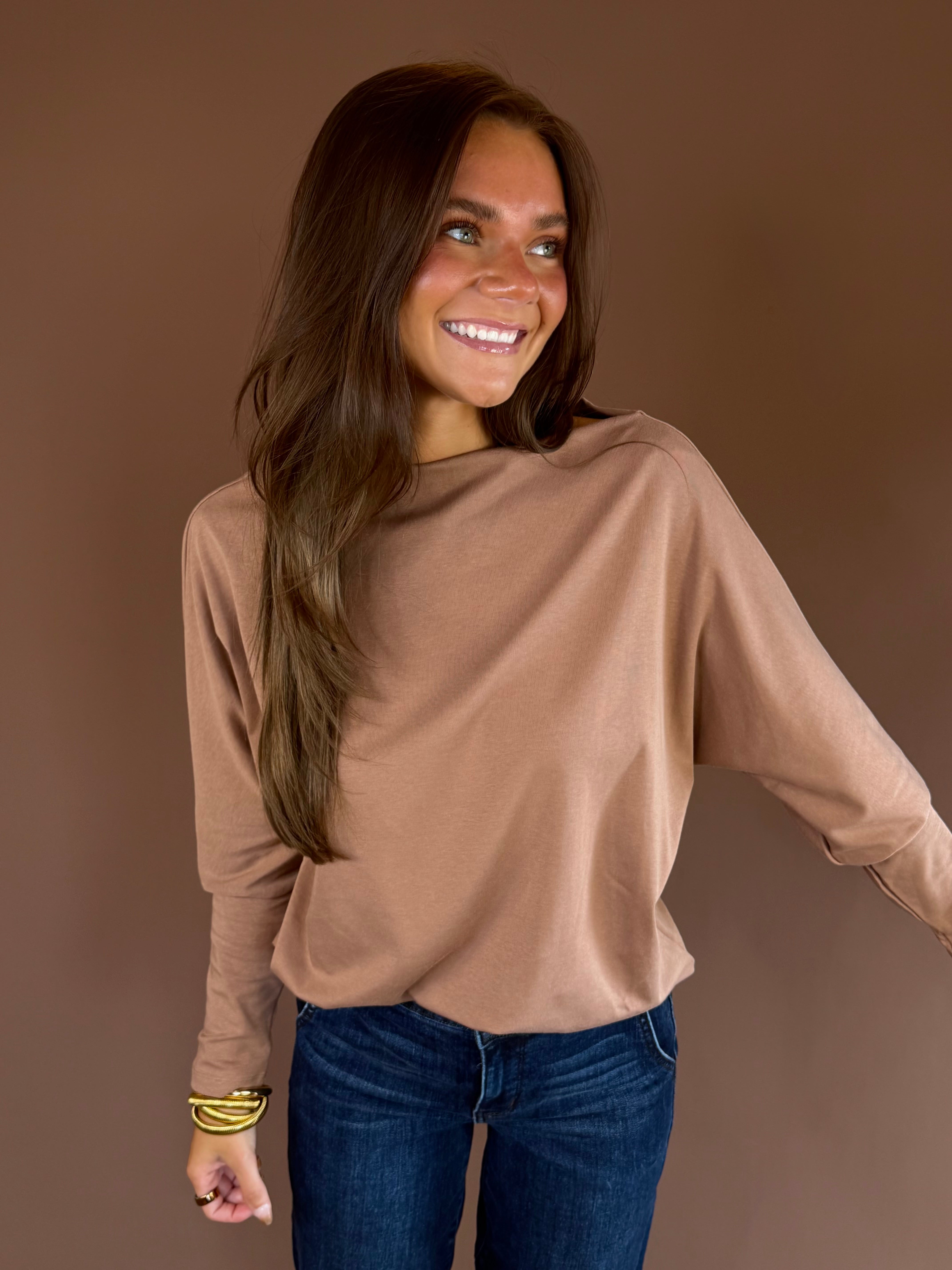 Almond brown knit sweater with a wide boat neckline, long dolman sleeves, and relaxed silhouette.