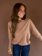 Almond brown knit sweater with a wide boat neckline, long dolman sleeves, and relaxed silhouette.