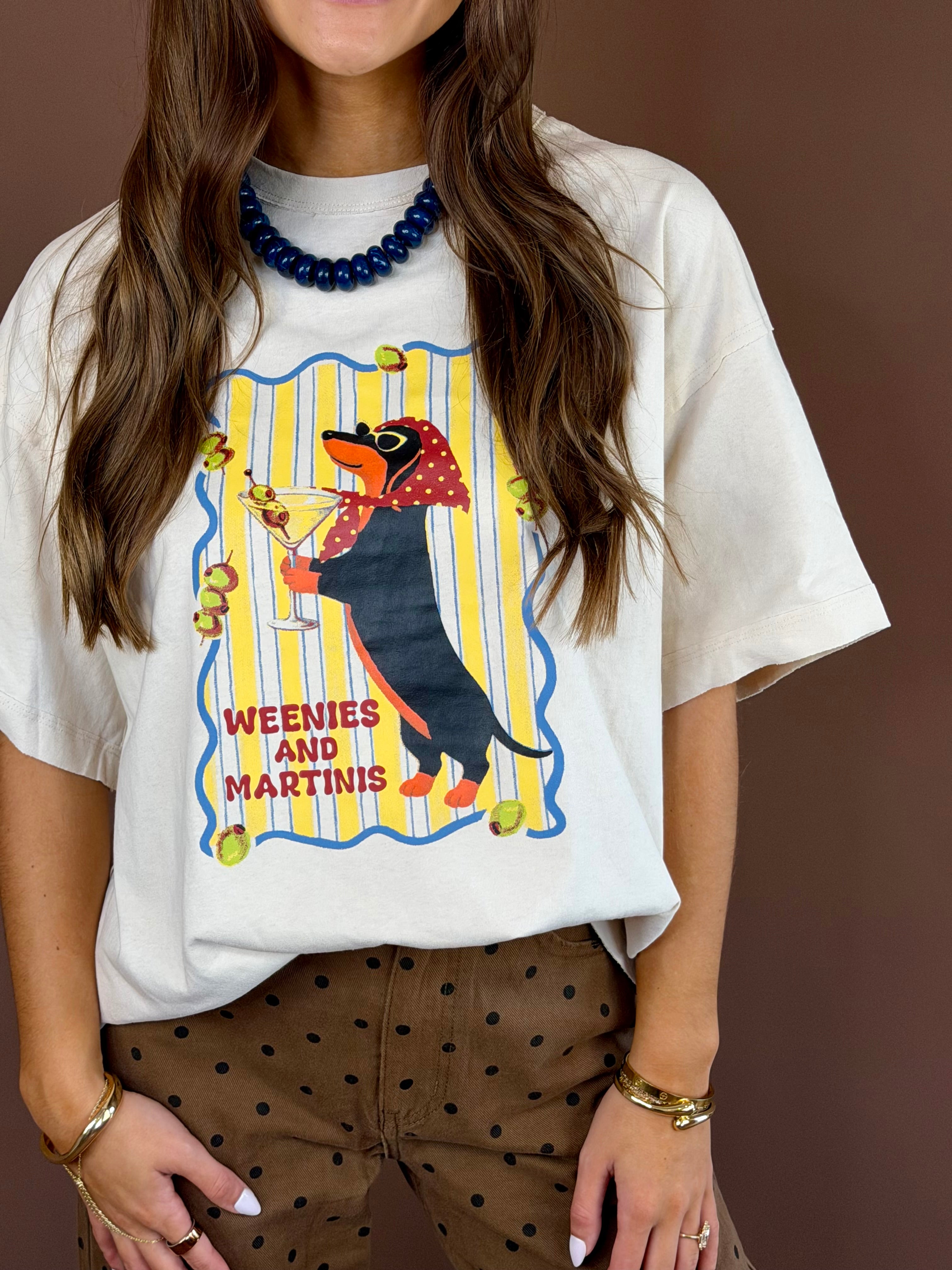 Weenies and Martinis women’s bone-white washed graphic T-shirt with a round neckline, short sleeves, and relaxed oversized fit