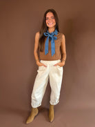 Sleeveless sweater-knit top with a removable denim tie neckline and mixed-texture Western-preppy design.